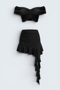 The Saint 54 black two-piece set with off-shoulder cropped top and asymmetrical ruffled mini skirt.