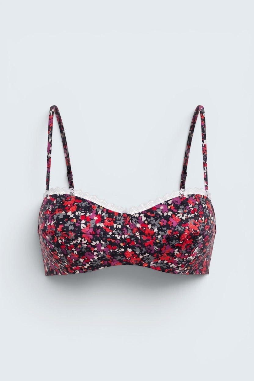The Saint 54 Give&Shine floral print shaping top with delicate ecru lace trim and adjustable spaghetti straps.