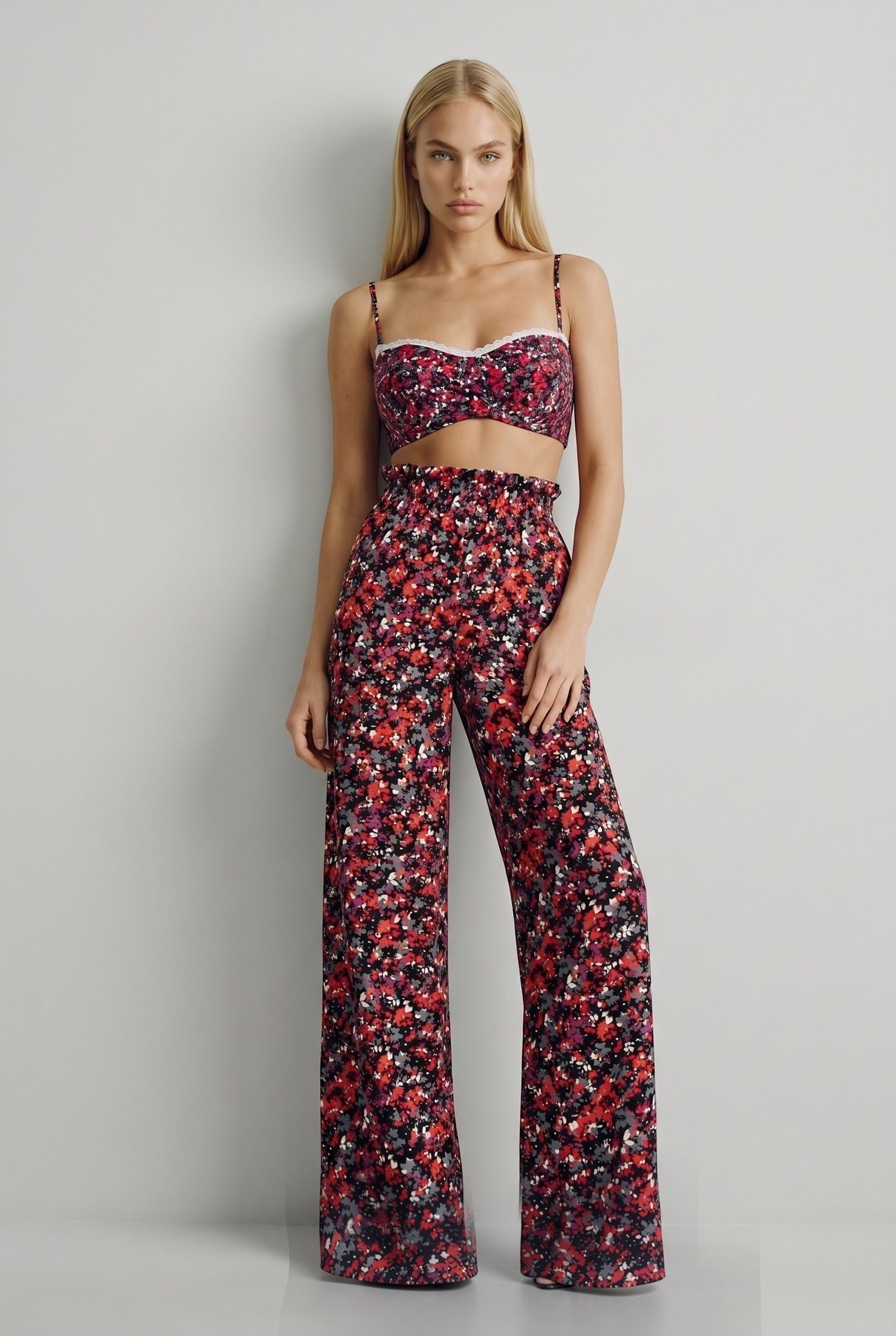 The Saint 54 floral print shaping top with delicate ecru lace trim and adjustable straps worn with matching trousers.