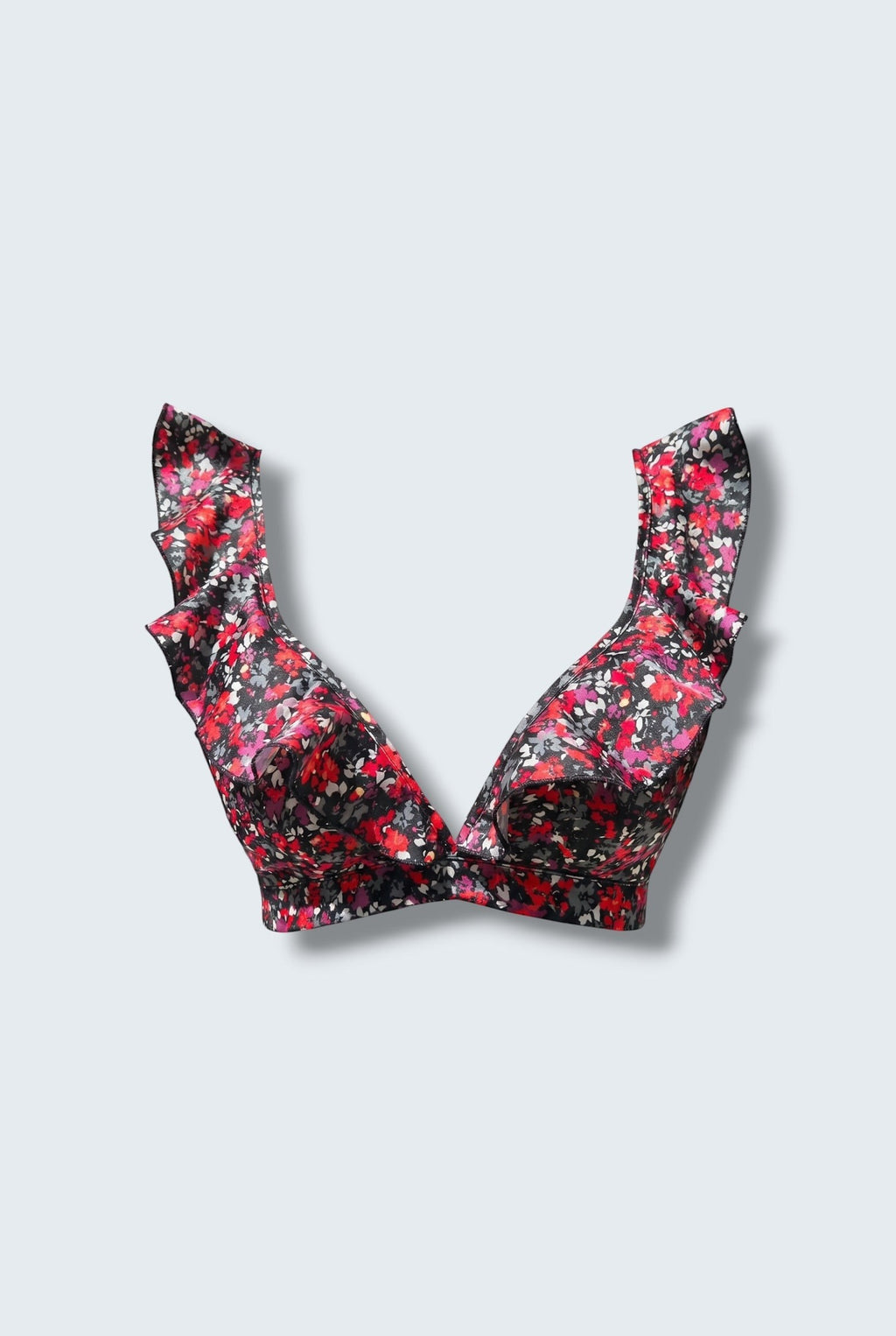 The Saint 54 Give&Shine floral print bikini top with statement ruffle straps and a picot edge finish.