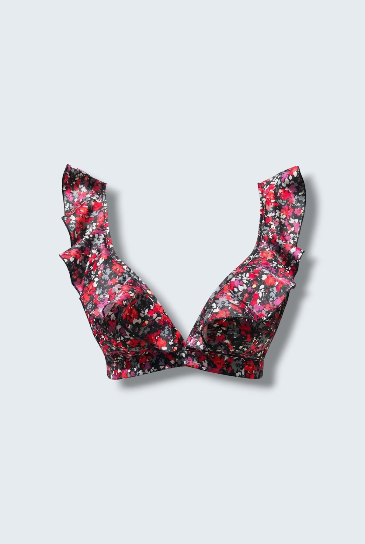 The Saint 54 Give&Shine floral print bikini top with statement ruffle straps and a picot edge finish.