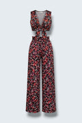 The Saint 54 floral print two-piece set featuring a tie-front crop vest and high-waisted wide-leg trousers.