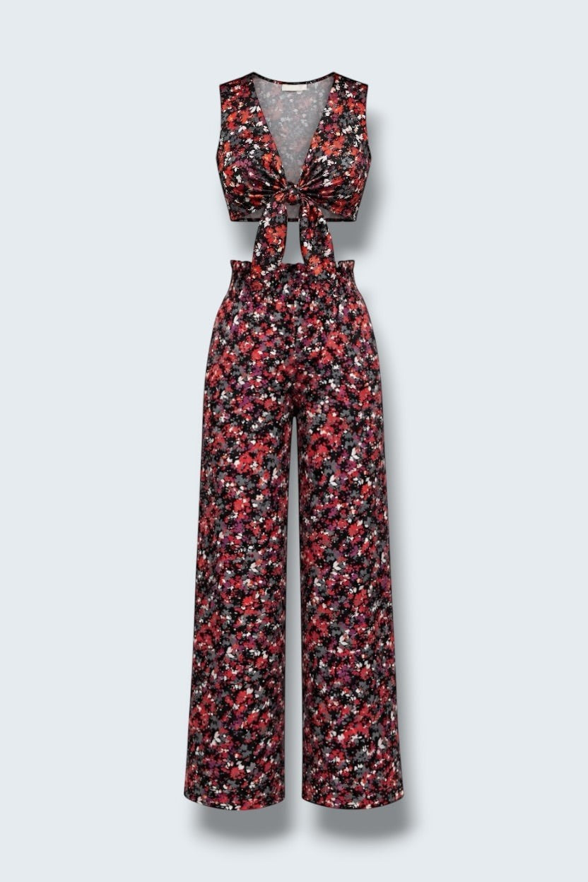 The Saint 54 floral print two-piece set featuring a tie-front crop vest and high-waisted wide-leg trousers.