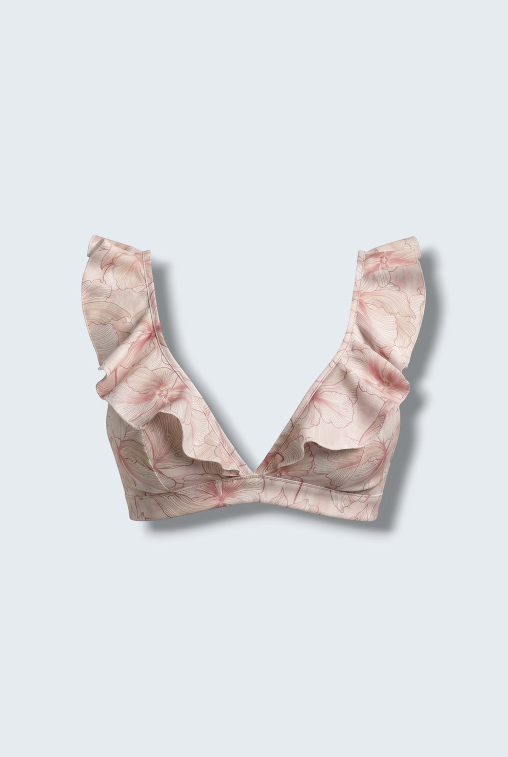 The Saint 54 pink floral bikini top featuring statement ruffle details and a deep V-neckline with picot edges.