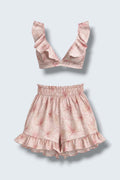 The Saint 54 pink floral two-piece set featuring a ruffled bralette top and high-waisted ruffled mini shorts.