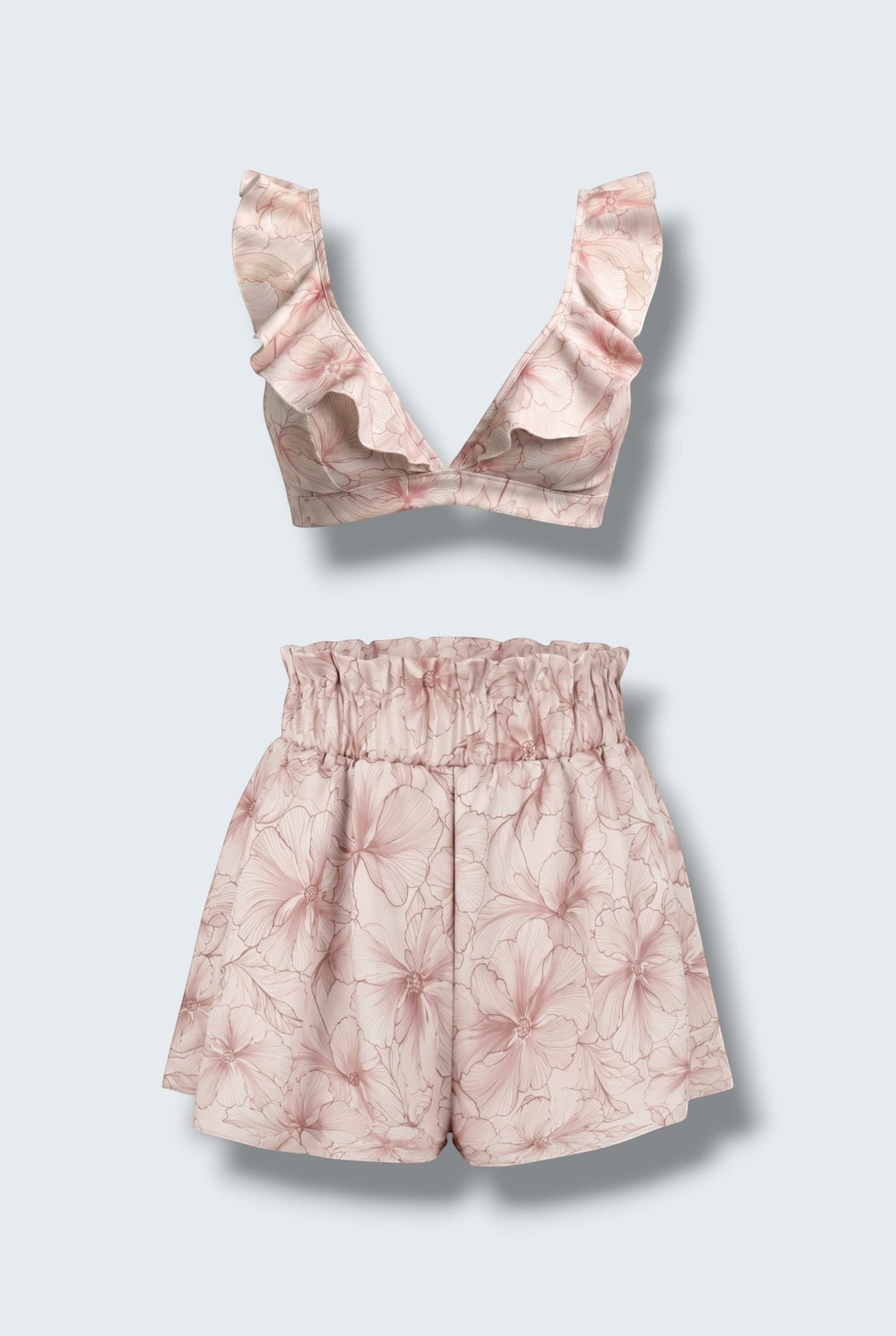 The Saint 54 pink floral two-piece set featuring a ruffled bralette top and high-waisted flared mini shorts.