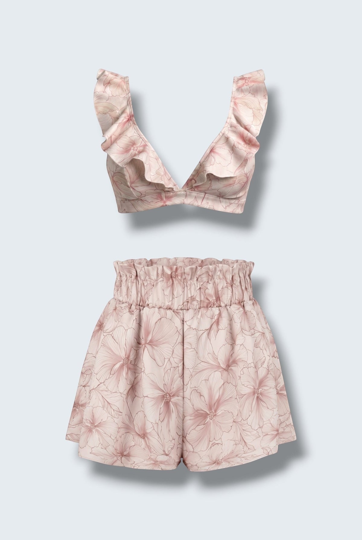 The Saint 54 pink floral two-piece set featuring a ruffled bralette top and high-waisted flared mini shorts.