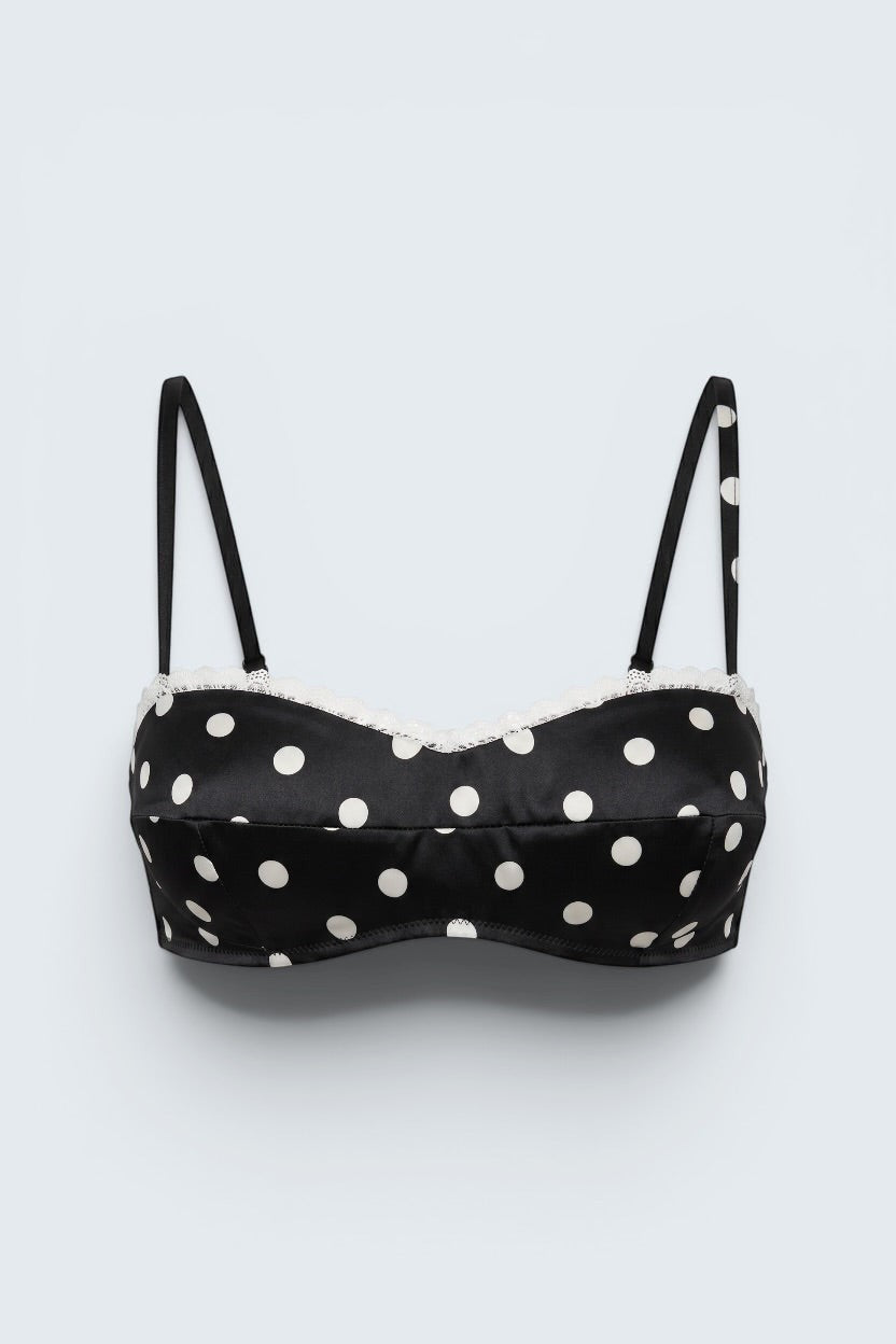 The Saint 54 black and white polka dot bustier top with delicate ecru lace trim and adjustable spaghetti straps.