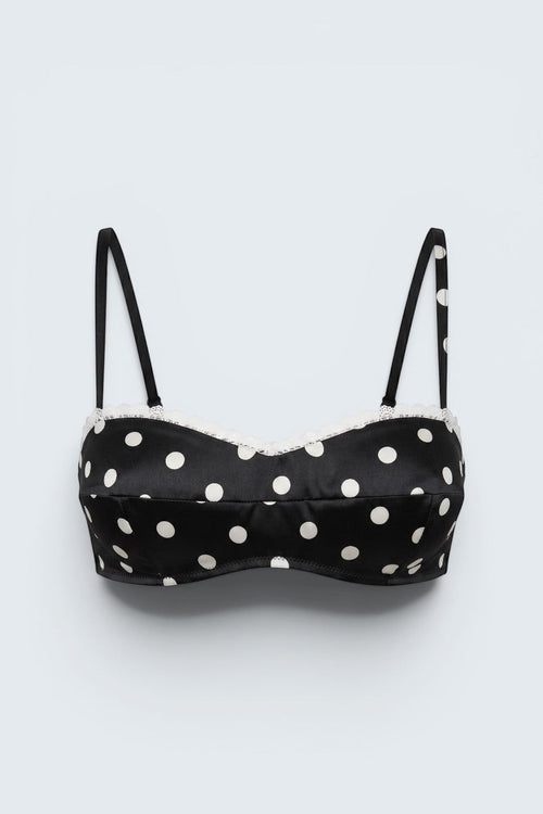 The Saint 54 black and white polka dot bustier top with delicate ecru lace trim and adjustable spaghetti straps.