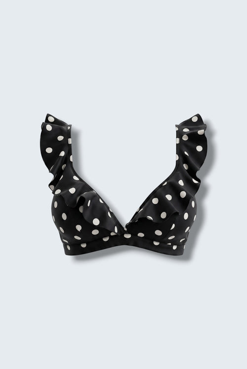The Saint 54 black bikini top with white polka dots, featuring statement ruffle details and picot edge finish.