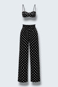 The Saint 54 Set Dolce Vita N2 featuring a black and white polka dot crop top and matching high-waisted wide-leg trousers.