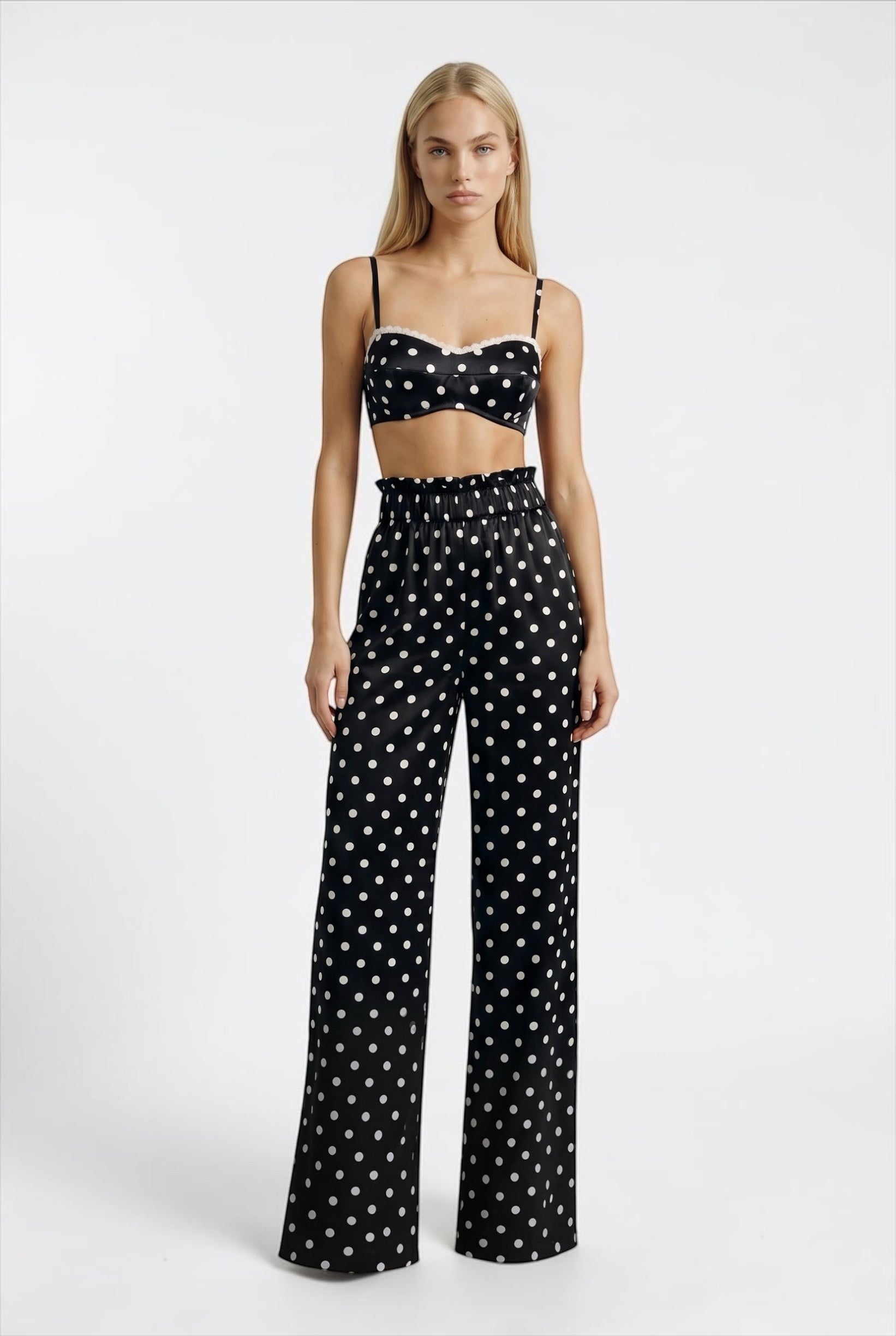 The Saint 54 Set Dolce Vita N2 featuring a black and white polka dot crop top and matching high-waisted wide-leg pants.