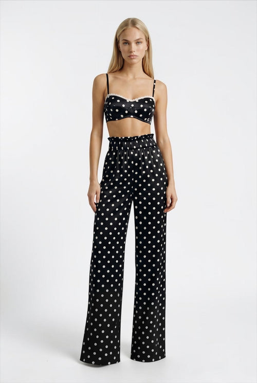 The Saint 54 Set Dolce Vita N2 featuring a black and white polka dot crop top and matching high-waisted wide-leg pants.