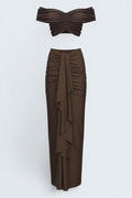 The Saint 54 brown ruched off-shoulder crop top and draped maxi skirt set.
